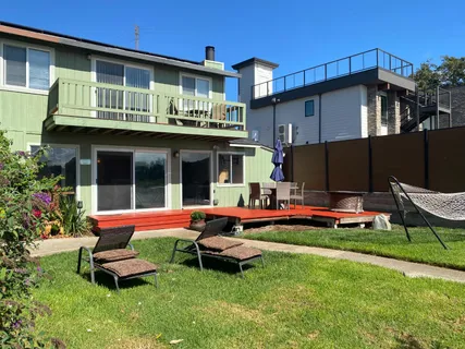 a view of a backyard with table and chairs