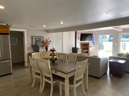 a dining room with furniture and a kitchen view