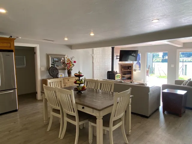 a dining room with furniture and a kitchen view