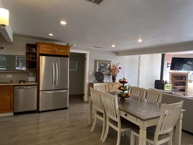 a kitchen with granite countertop a refrigerator stove and microwave