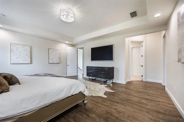 a bedroom with a bed and a television