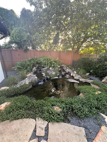 a garden with lots of trees and flowers