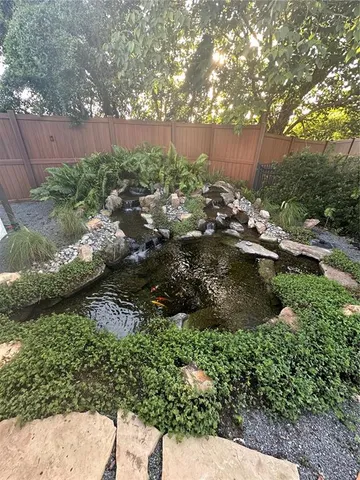 a view of a backyard with plants and a bench
