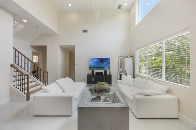 a living room with fireplace furniture and a large window