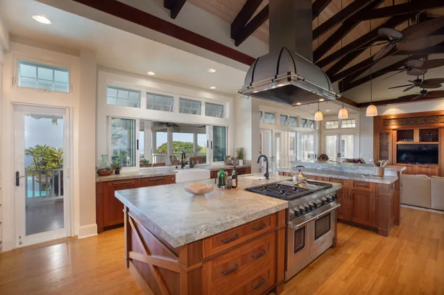 a large kitchen with stainless steel appliances kitchen island granite countertop a sink and cabinets