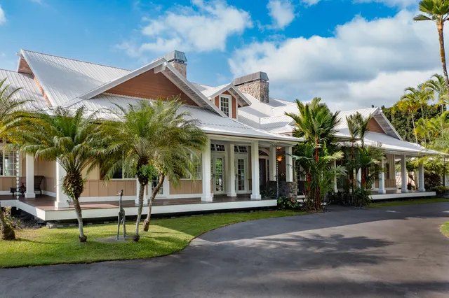 an aerial view of a house with yard and outdoor seating