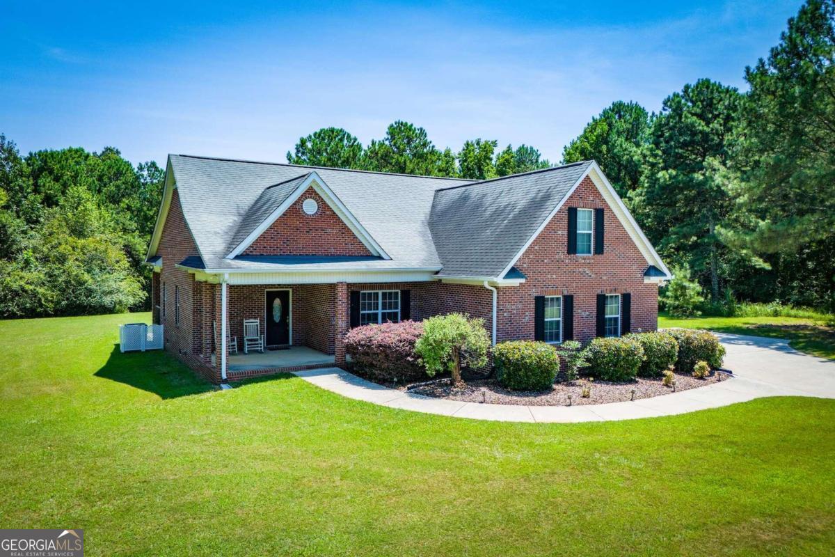 5045 Stateline Road Bowdon, GA 30108 - Photo 1 of 1 a front view of house with yard and green space