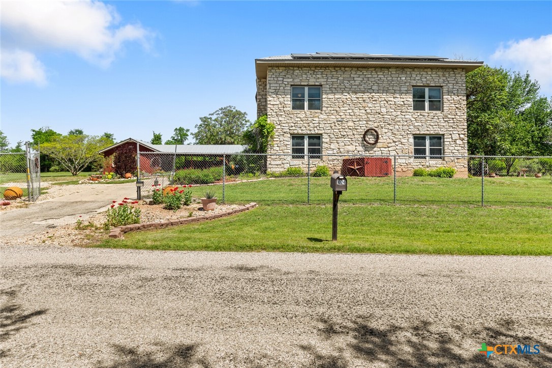 a front view of house with outdoor space and lake view