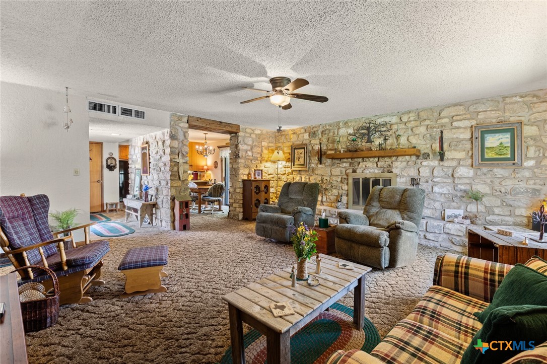1024 Backstrom Crossing Belton, TX 76513 - Photo 11 of 47 a living room with furniture and a chandelier