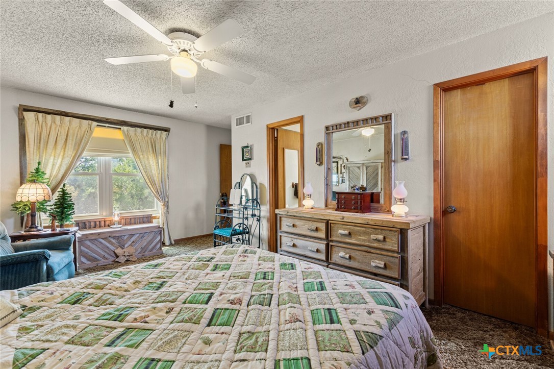 1024 Backstrom Crossing Belton, TX 76513 - Photo 15 of 47 a bedroom with a large bed and a large window