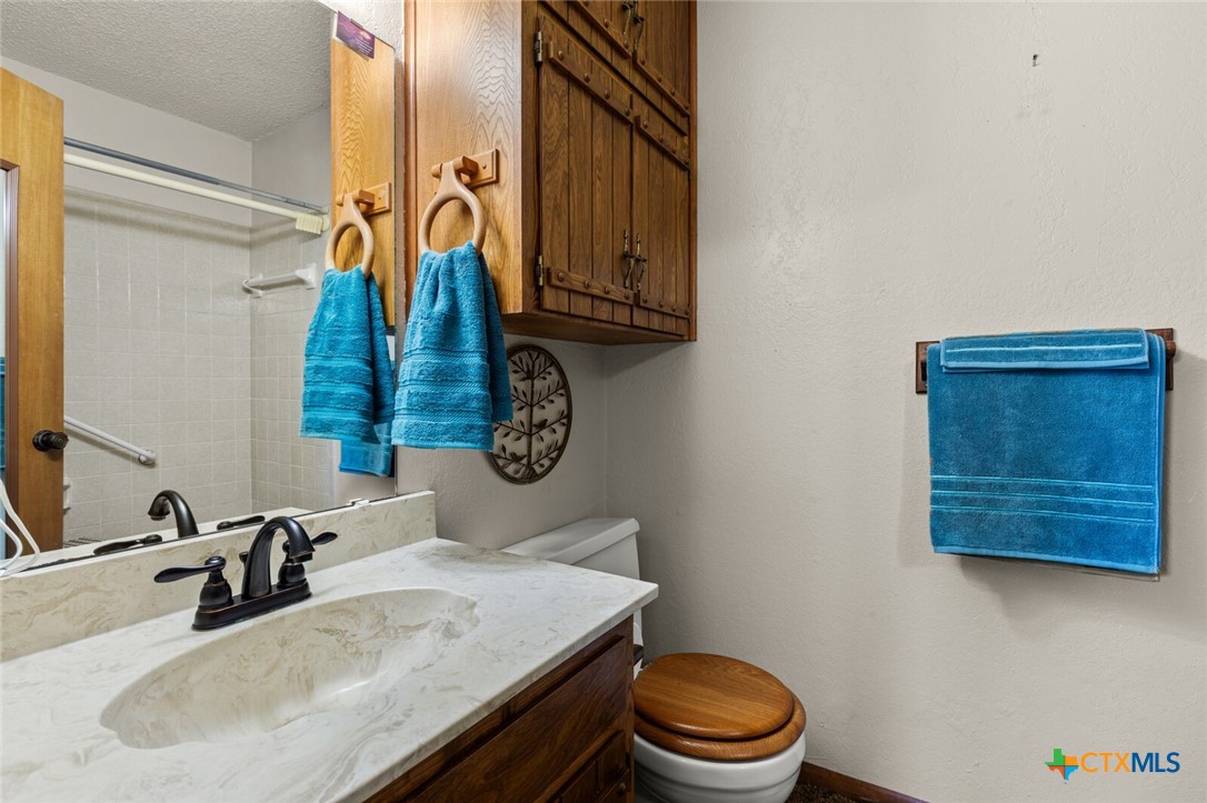 1024 Backstrom Crossing Belton, TX 76513 - Photo 18 of 47 a bathroom with a sink a toilet and a mirror