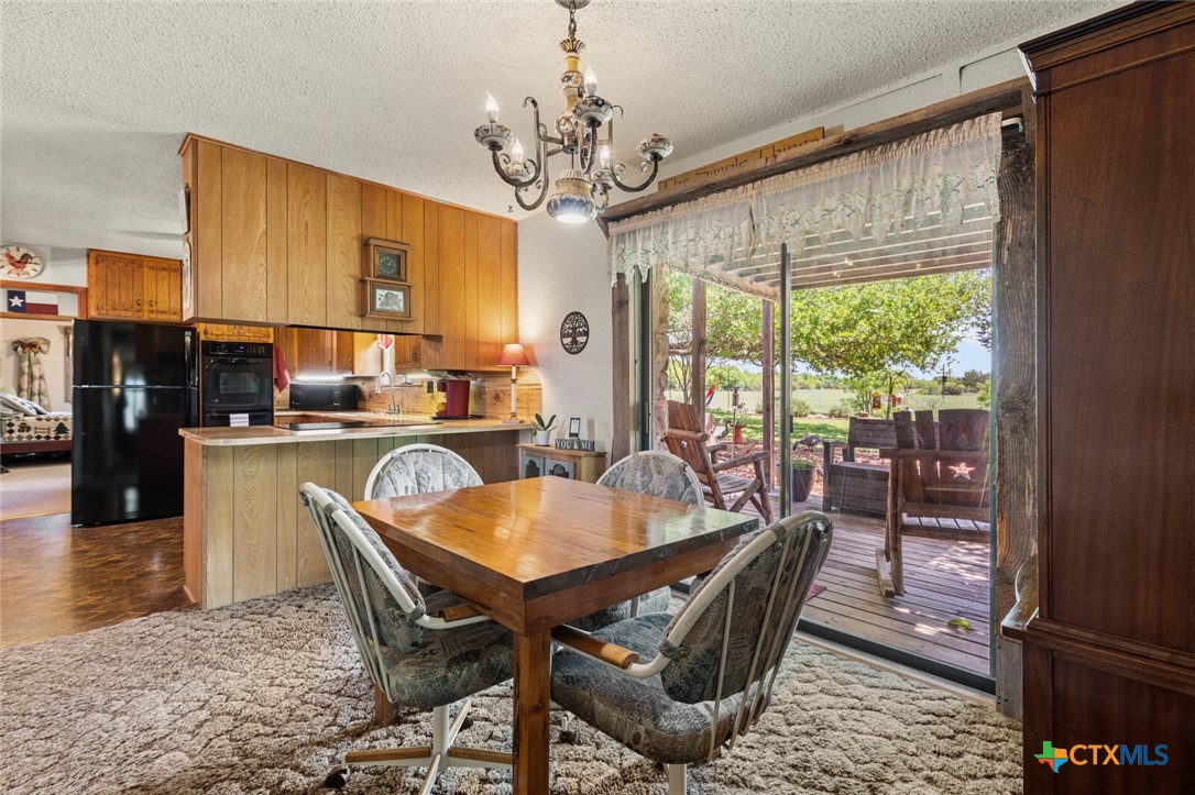 1024 Backstrom Crossing Belton, TX 76513 - Photo 19 of 47 a dining room with furniture a chandelier and wooden floor