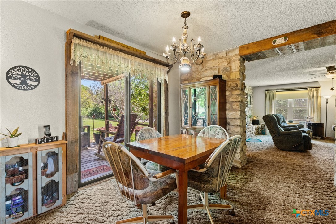1024 Backstrom Crossing Belton, TX 76513 - Photo 20 of 47 a living room with furniture and a chandelier