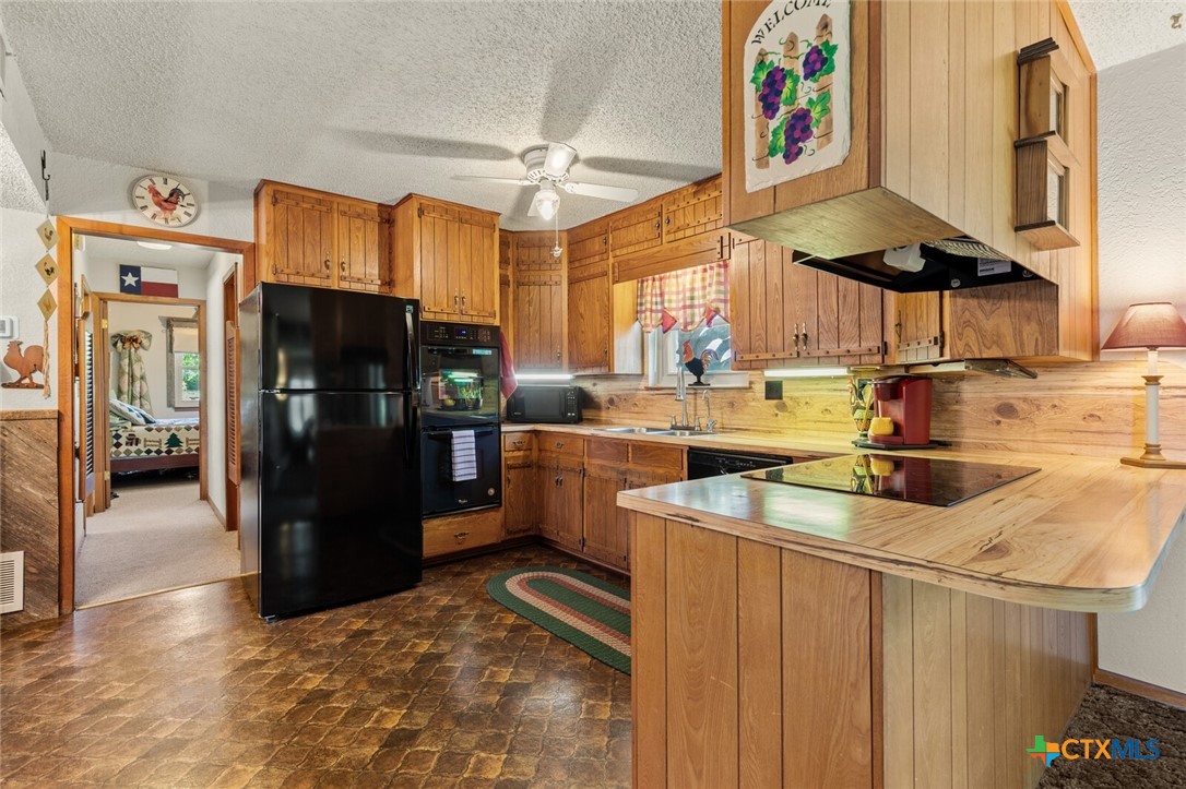 1024 Backstrom Crossing Belton, TX 76513 - Photo 22 of 47 a kitchen with refrigerator and cabinets