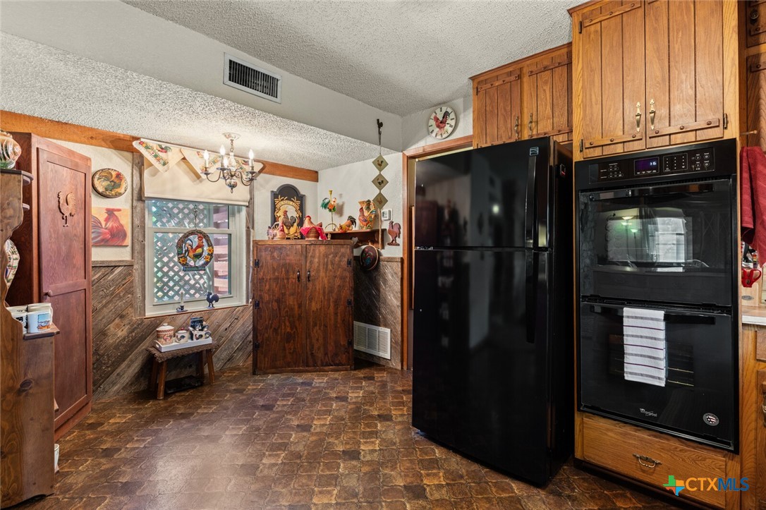 1024 Backstrom Crossing Belton, TX 76513 - Photo 24 of 47 a kitchen with stainless steel appliances granite countertop a refrigerator and a sink