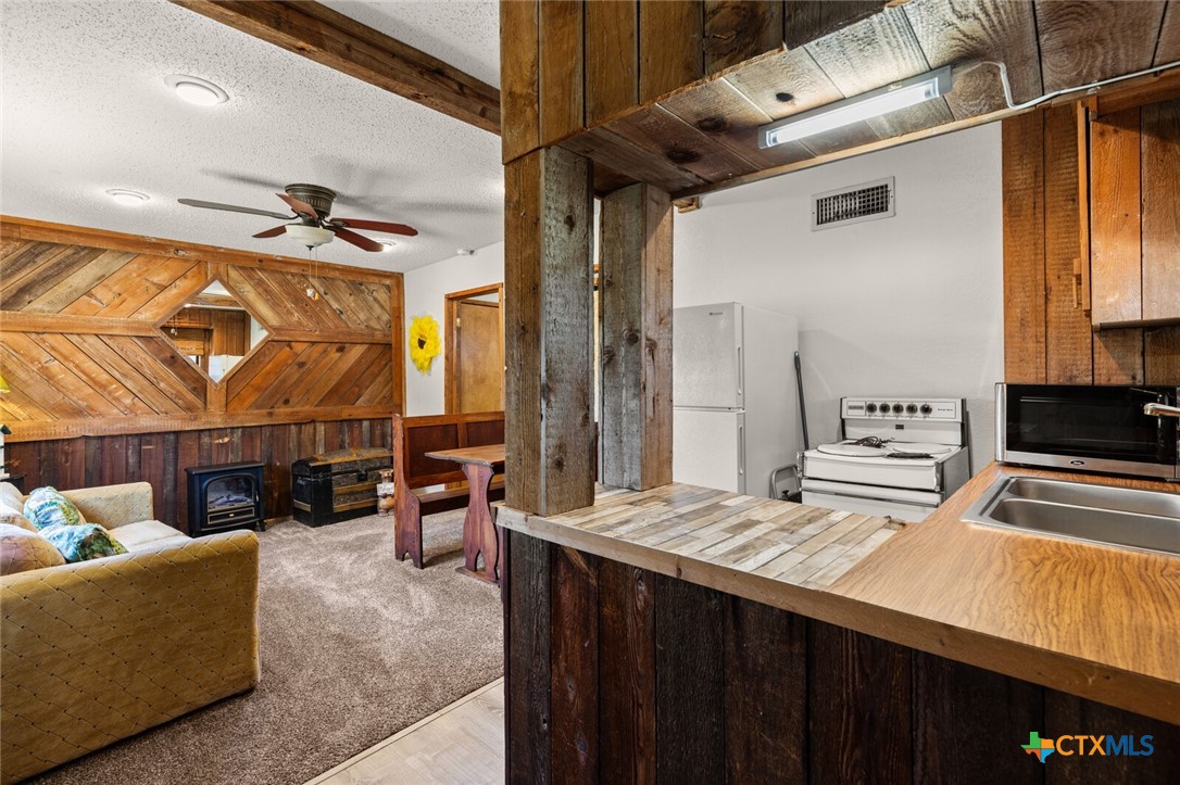 1024 Backstrom Crossing Belton, TX 76513 - Photo 37 of 47 a kitchen with stainless steel appliances kitchen island granite countertop a sink and cabinets