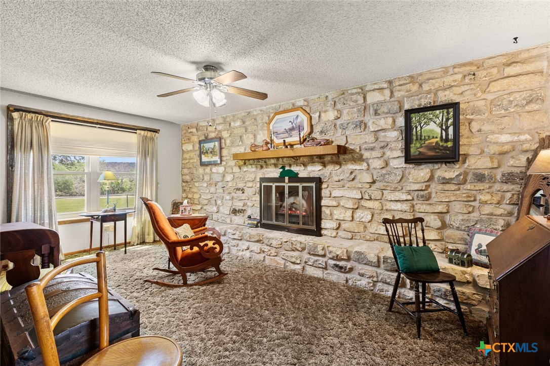 1024 Backstrom Crossing Belton, TX 76513 - Photo 9 of 47 a living room with furniture a fireplace and a flat screen tv