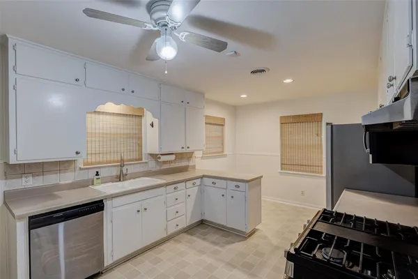 a kitchen with a sink stove and cabinets