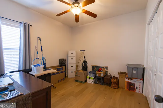 a view of a workspace with furniture and a window