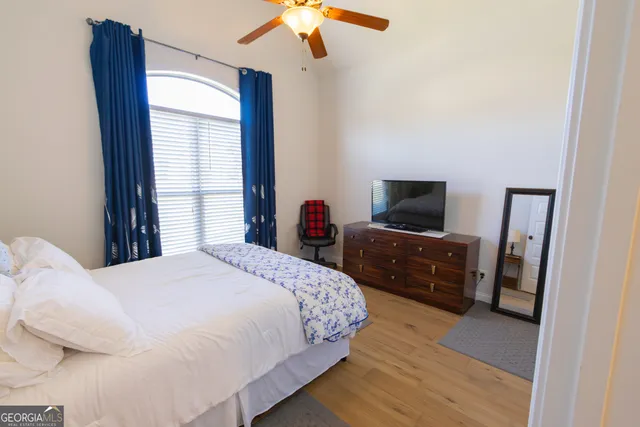 a bedroom with a bed and a television