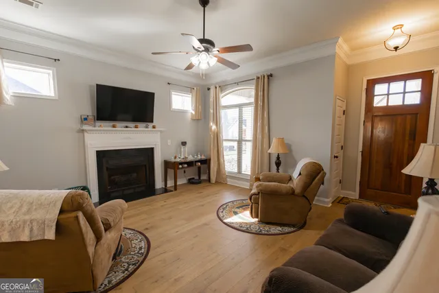 a living room with furniture a fireplace and a flat screen tv