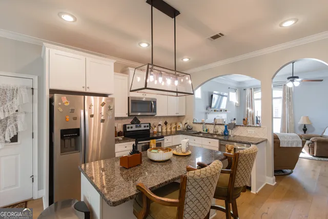 a kitchen with sink refrigerator and cabinets