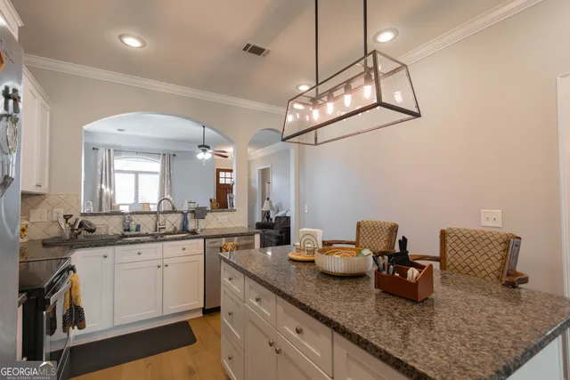 a kitchen with sink and cabinets