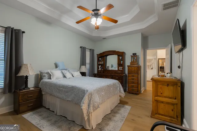 a bedroom with a bed and a television