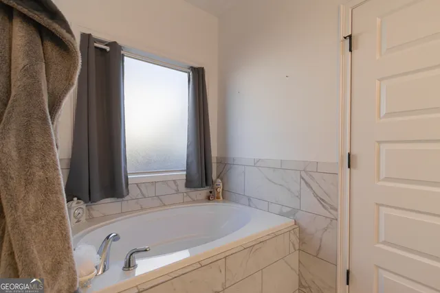 a bathroom with a tub and shower