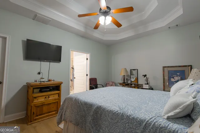 a bedroom with a bed and a flat screen tv