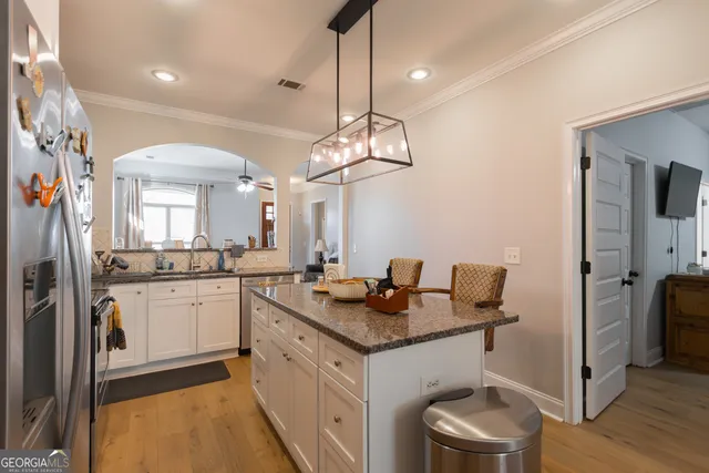 a kitchen with a sink stove and refrigerator