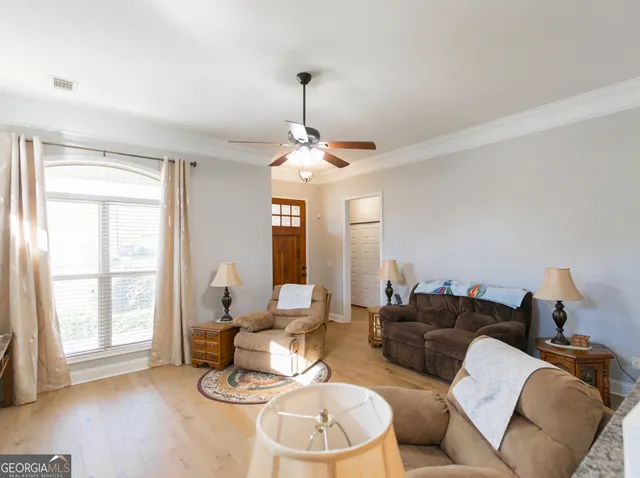 a living room with furniture a window and a chandelier