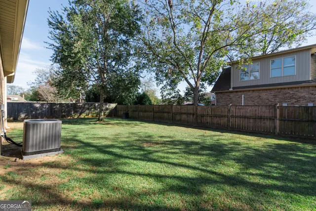 a view of a backyard with a tree