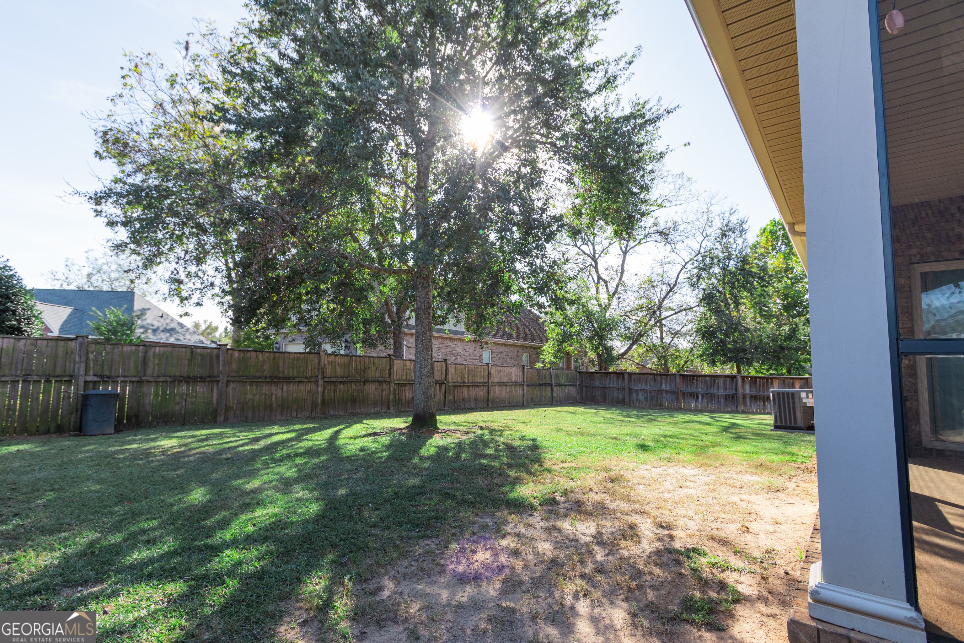 135 Parkview Grove Kathleen, GA 31047 - Photo 8 of 35 a view of a backyard with a large tree and wooden fence