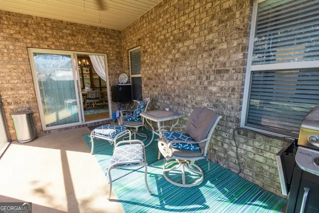 a patio with table and chairs