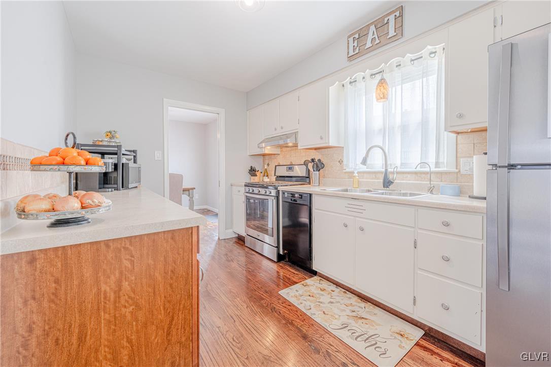 413 South Miller Street Shillington, PA 19607 - Photo 6 of 36 a kitchen with a sink a stove cabinets and wooden floor