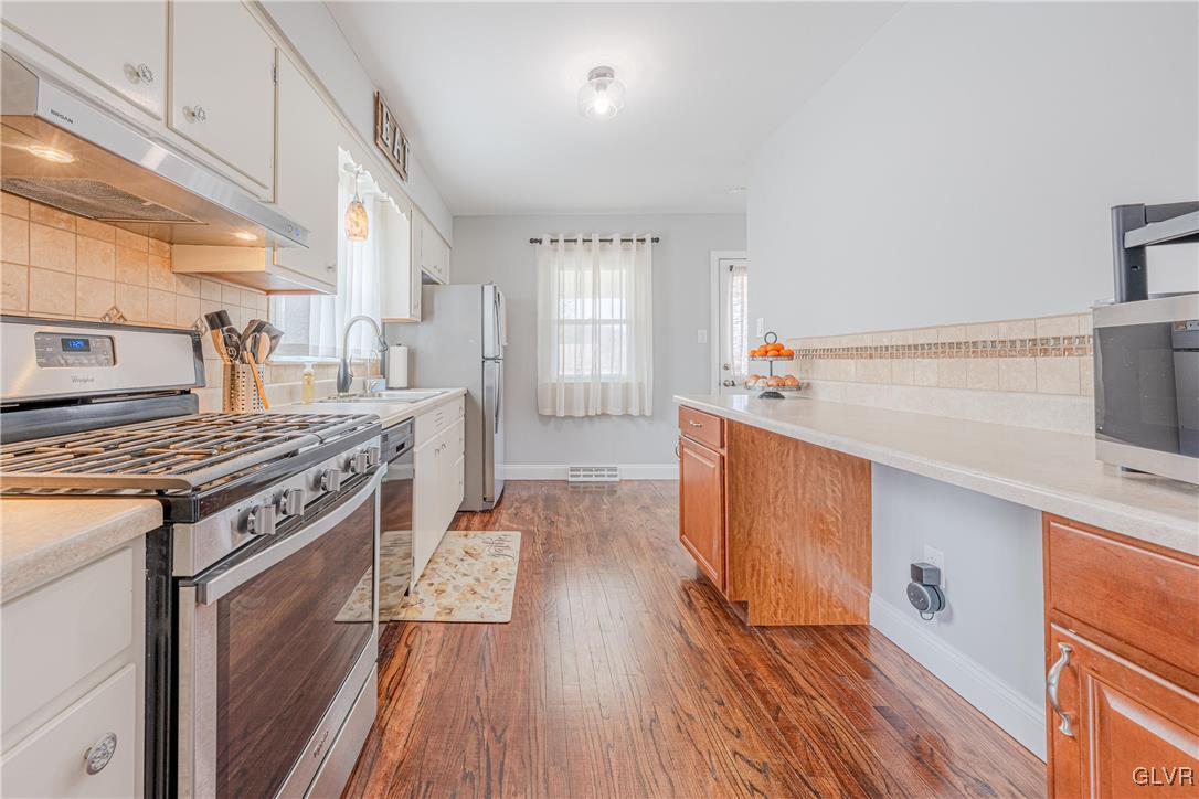 413 South Miller Street Shillington, PA 19607 - Photo 8 of 36 a kitchen with a stove and wooden floor