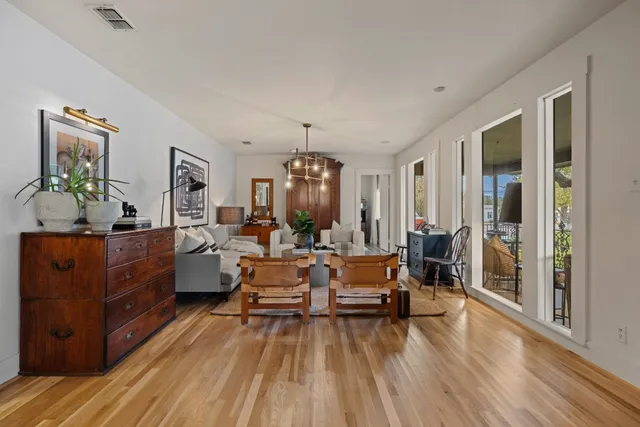 a view of living room filled with furniture and wooden floor