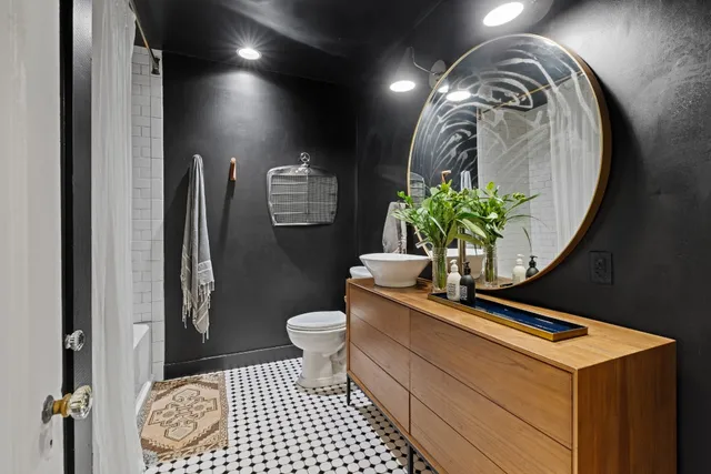 a bathroom with a sink a toilet and a shower