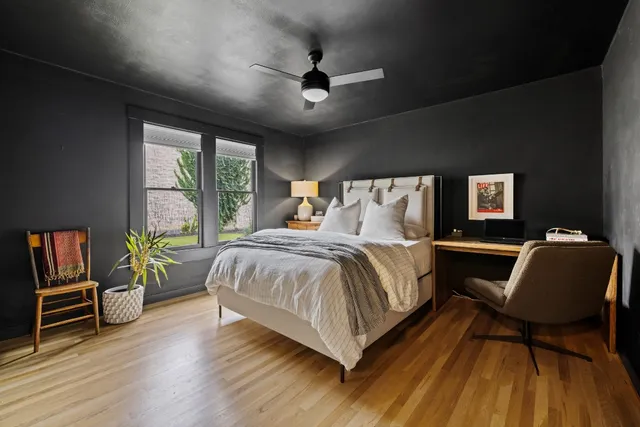 a bedroom with a bed and wooden floor
