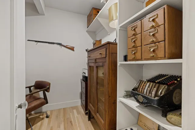 a view of walk in closet with clothes and shoes