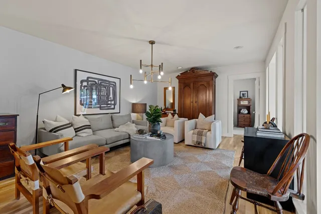 a living room with furniture and a chandelier
