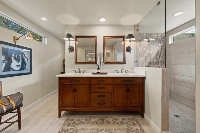 a bathroom with double vanity sink and a mirror