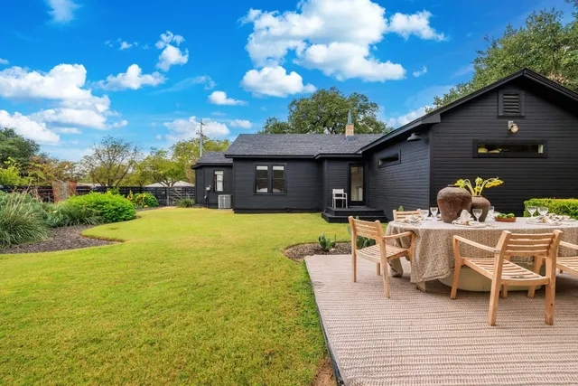 a view of a patio with table and chairs with wooden floor and fence