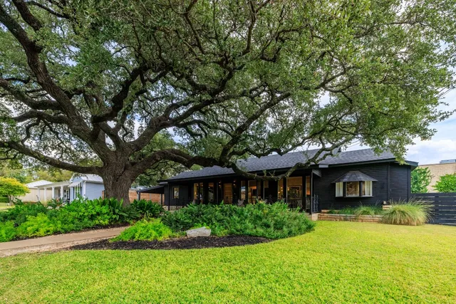 a front view of a house with a yard and porch