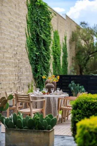 a backyard of a house with table and chairs