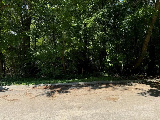 a view of wooden fence and trees