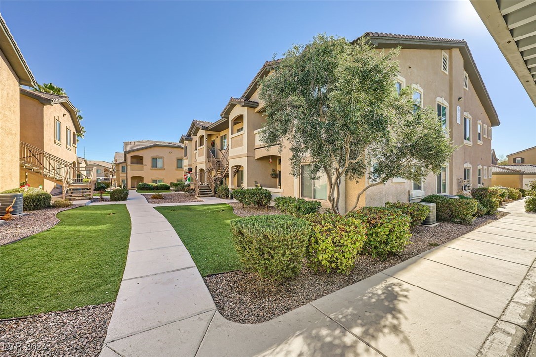 8985 South Durango Drive, Unit 2117 Las Vegas, NV 89113 - Photo 4 of 24 View of walkway from Carport