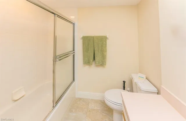 a white toilet sitting next to a bathroom sink