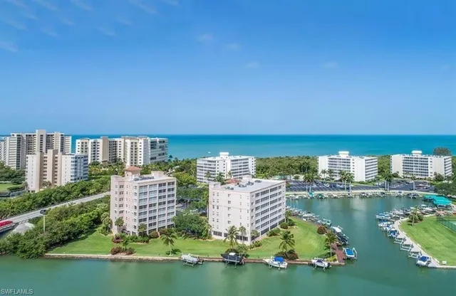 a view of a house with a yard and a pond